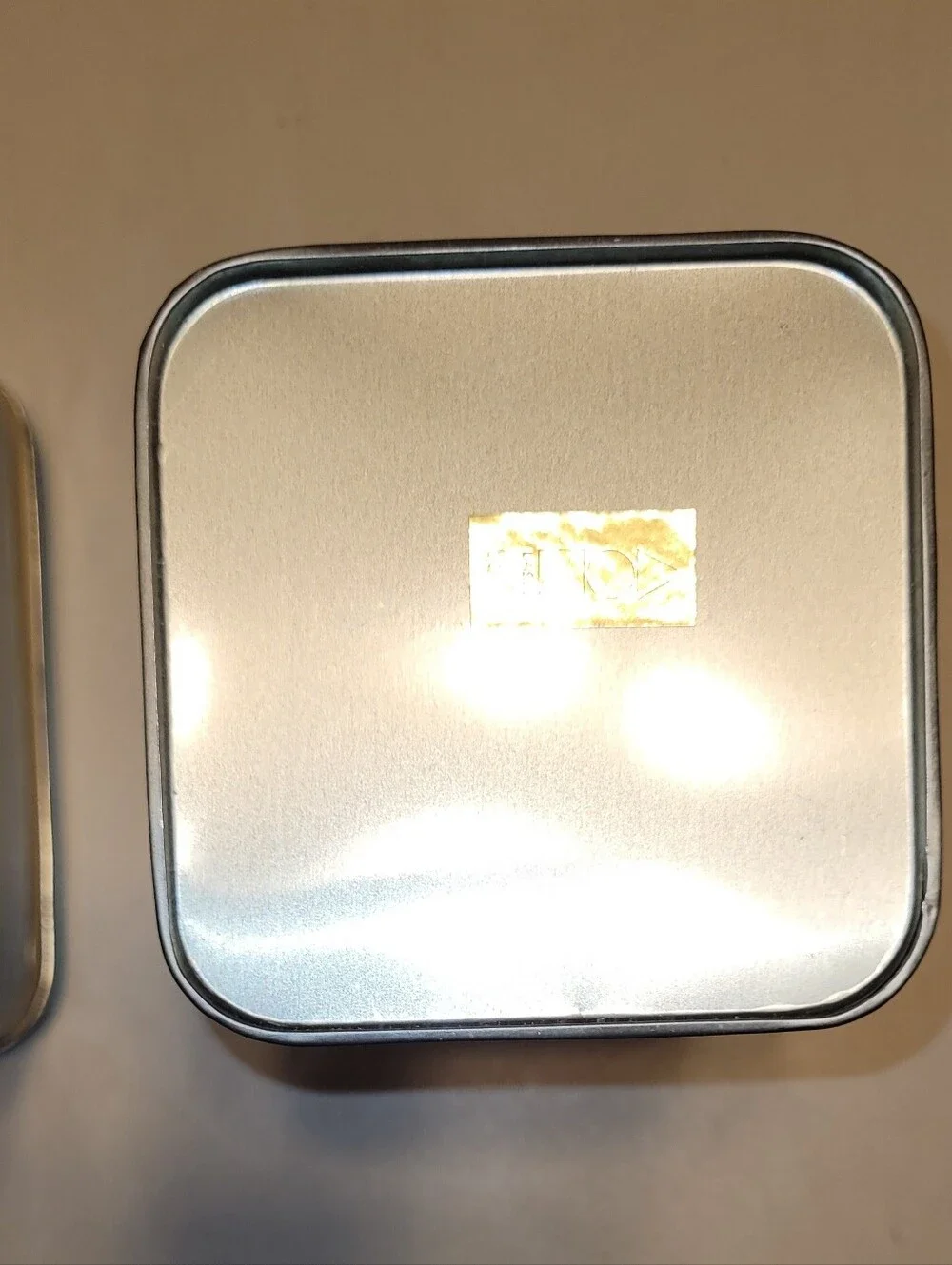 LASLO - Set of 3 Nesting Tan Metal Canisters with Green Lids and Stripes.